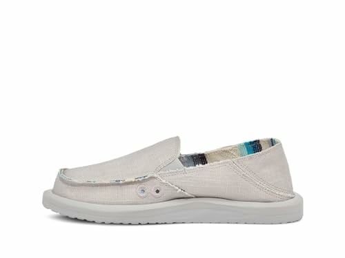 Casual slip-on shoe with white sole and patterned interior.